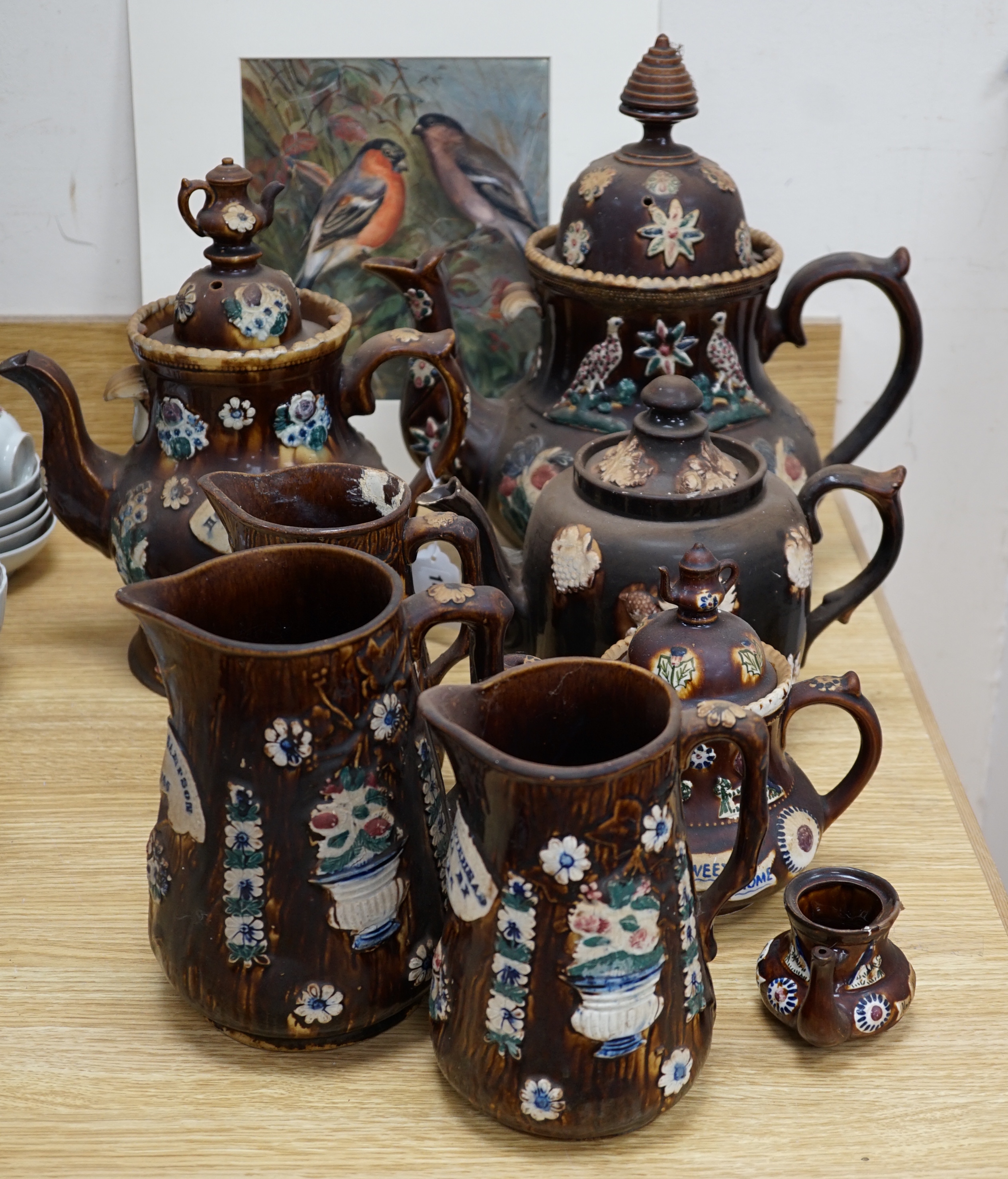 Measham Barge ware glazed pottery including teapots and jugs, decorated in relief, largest 28cm wide